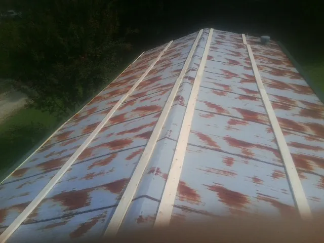 Rusted metal roof panels with new wood purlins before replacement — Storm Damage Roof Repair in Castle Creek by Roofing Brothers